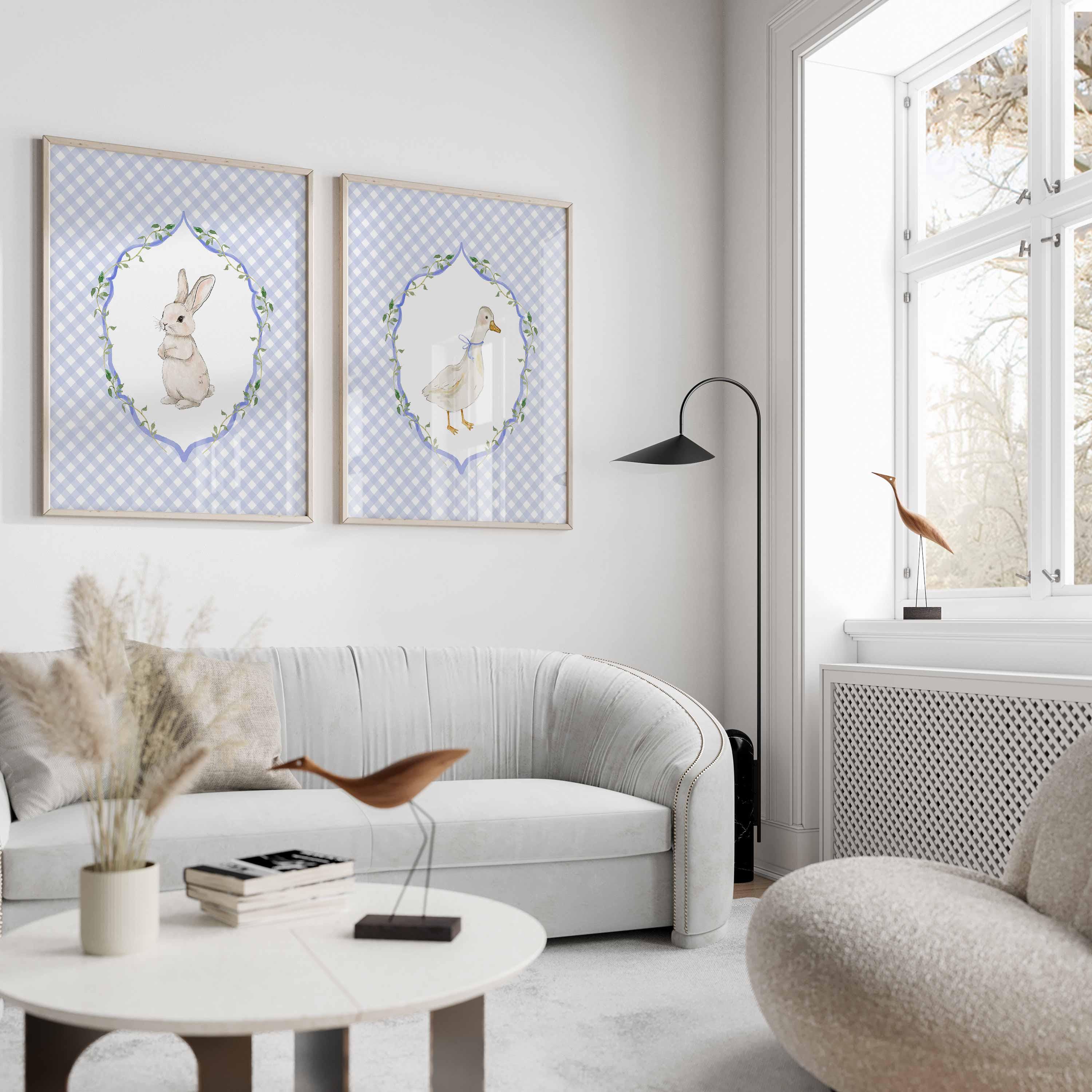 Blue gingham bunny and goose prints above a curved white sofa