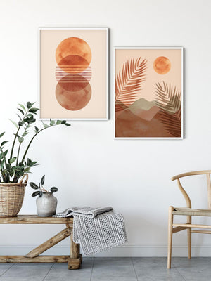 Stacked terracotta moons and a desert palm print above a wooden bench