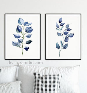 Two navy eucalyptus branch prints above a white sofa