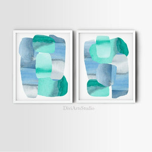 Two turquoise and slate abstract prints in white frames