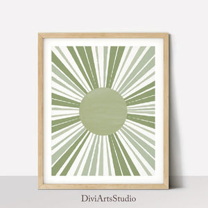 Sage green sun with long brushed rays leaning on a shelf