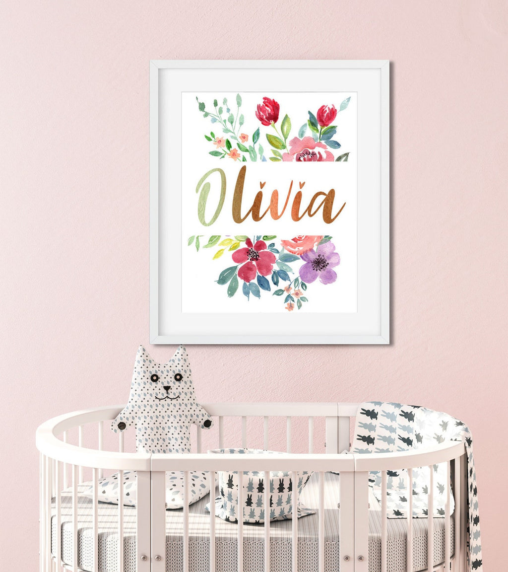 Olivia floral name print above a round crib against a pink wall