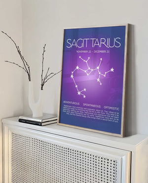 Sagittarius zodiac poster with the constellation over a purple aura on a shelf